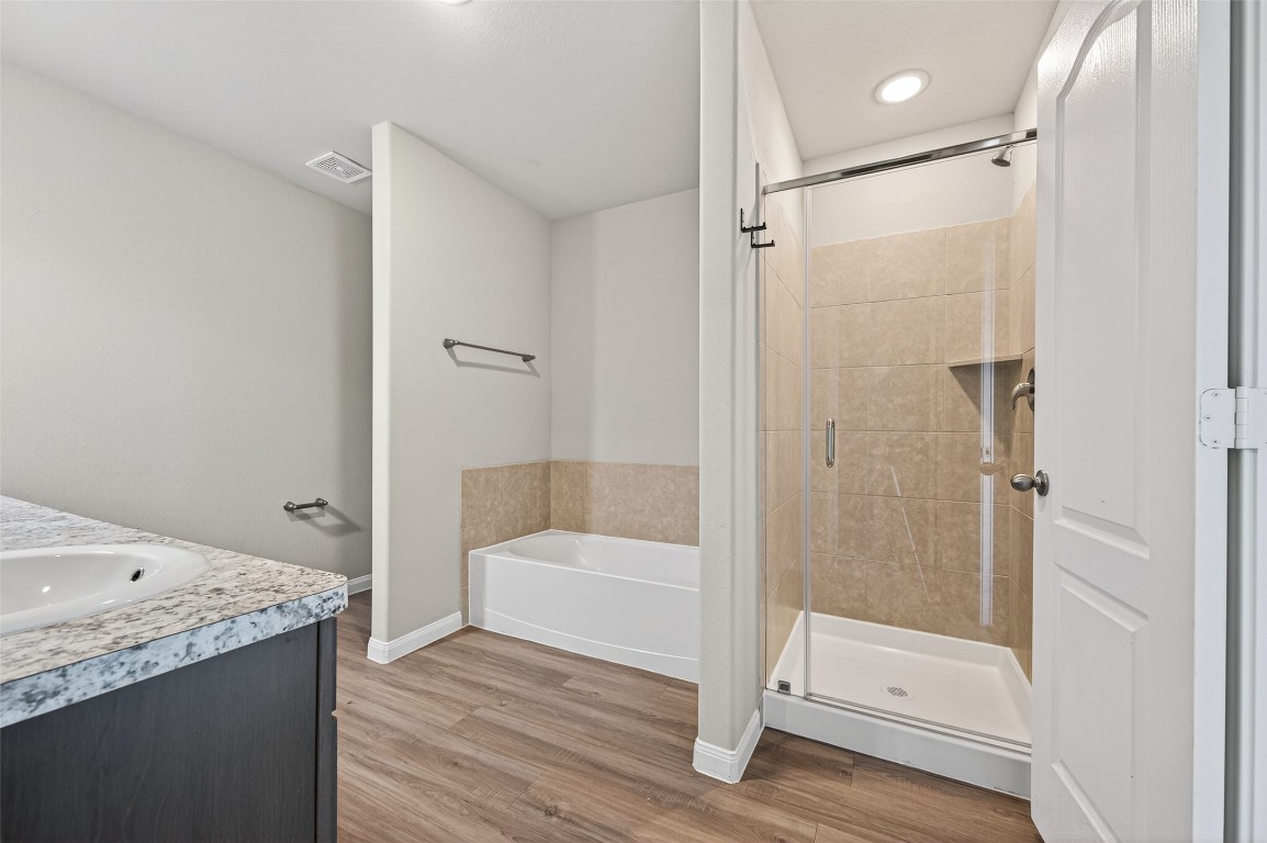 940 21st Street Hempstead, TX 77445 - Photo 30 of 36 a bathroom with a tub and shower