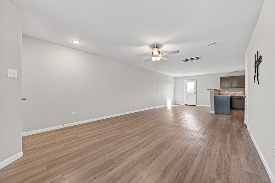 940 21st Street Hempstead, TX 77445 - Photo 4 of 36 a view of an empty room with a window and wooden floor