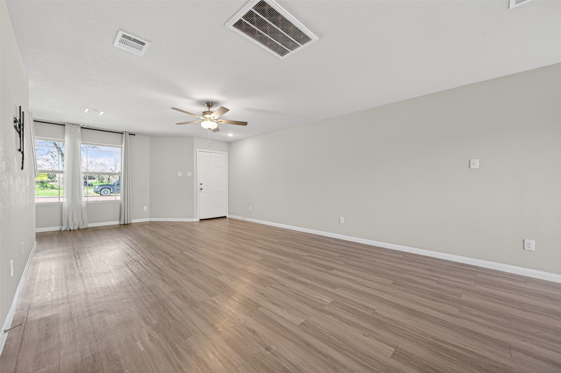 940 21st Street Hempstead, TX 77445 - Photo 7 of 36 wooden floor in an empty room with a window