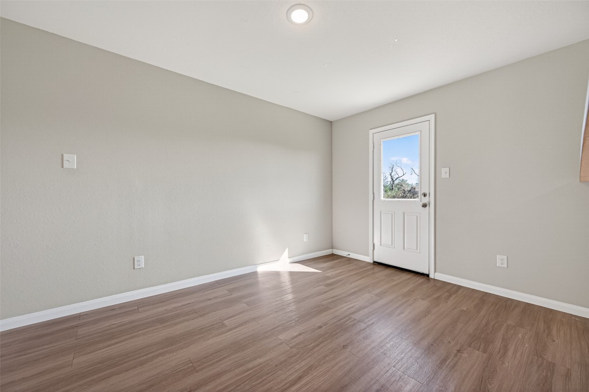 940 21st Street Hempstead, TX 77445 - Photo 8 of 36 a view of an empty room with wooden floor