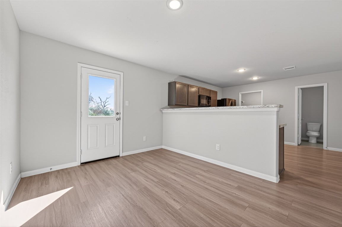 940 21st Street Hempstead, TX 77445 - Photo 9 of 36 a view of a kitchen with wooden floor and electronic appliances