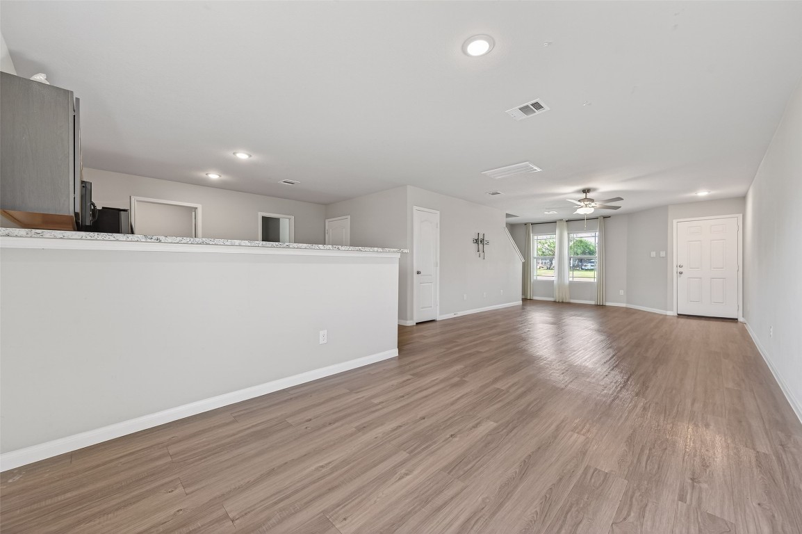 940 21st Street Hempstead, TX 77445 - Photo 10 of 36 a view of an empty room with wooden floor and a window