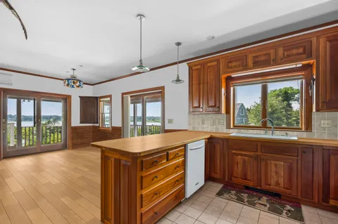 a kitchen that has a sink stove and cabinets