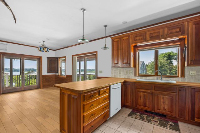 a kitchen that has a sink stove and cabinets