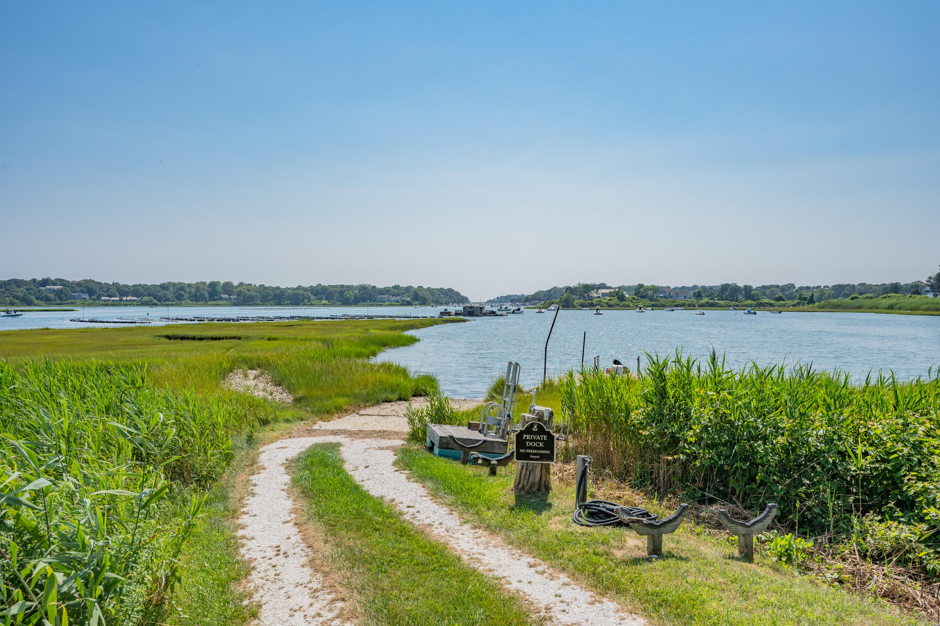 99 Uncle Alberts Drive Chatham, MA 02633 - Photo 15 of 32 a view of a lake with houses in the back