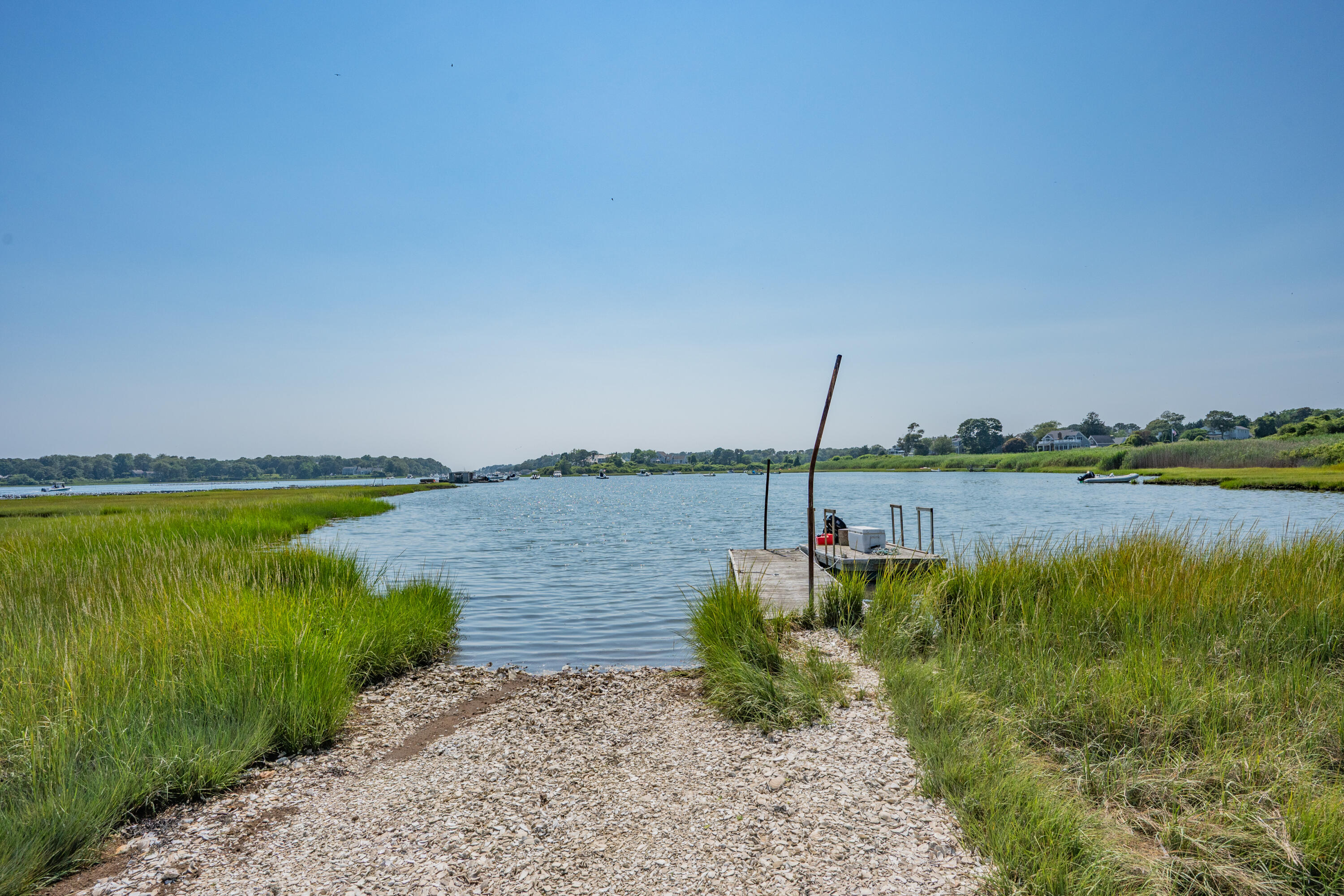 99 Uncle Alberts Drive Chatham, MA 02633 - Photo 16 of 32 a view of a lake from a yard