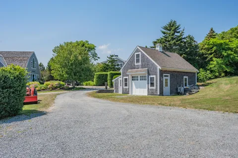 an aerial view of ocean with residential house and outdoor space