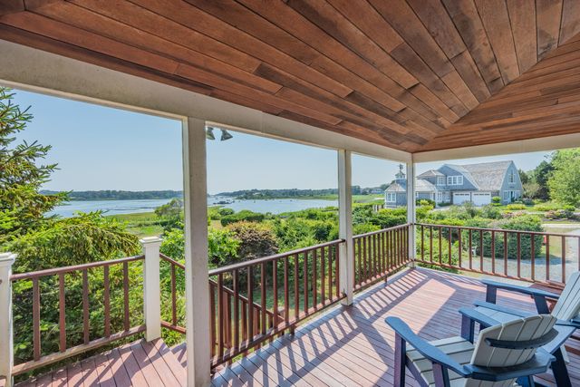a view of a balcony with lake view and wooden floor