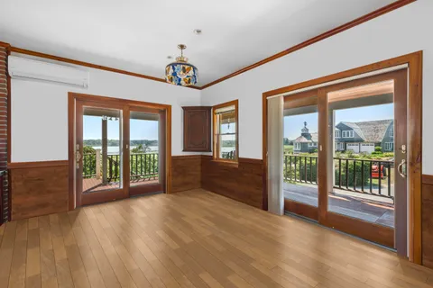 a view of an entryway with wooden floor