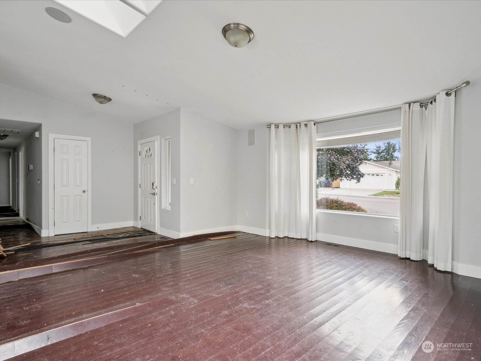 100 Torres Court Sequim, WA 98382 - Photo 5 of 26 a view of an empty room with wooden floor and window