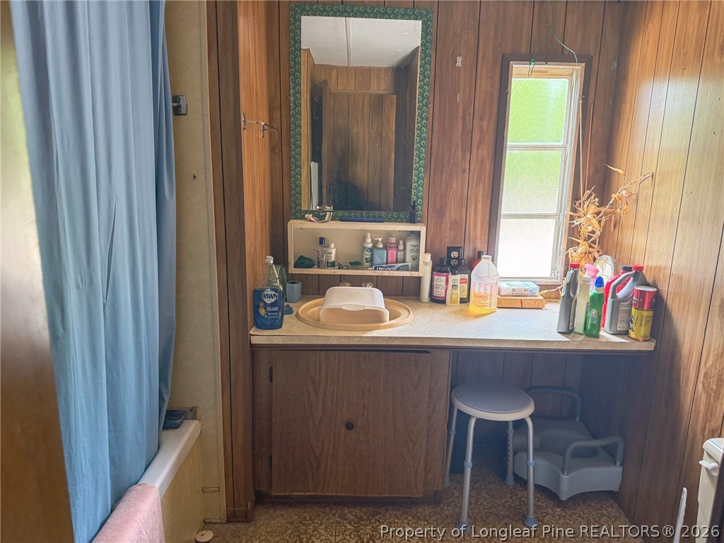 1308 Mac D Road Orrum, NC 28369 - Photo 9 of 32 a bathroom with a sink and a mirror