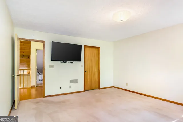 a bedroom with a bed and dresser