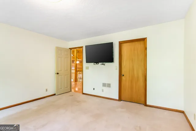 a spacious bedroom with a bed and a window