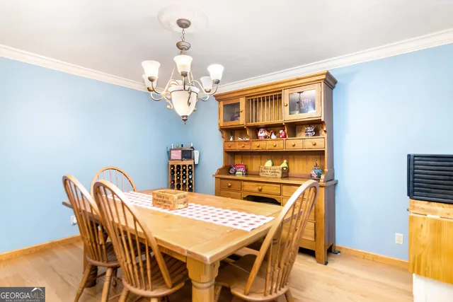 a view of a dining room with furniture and chandelier