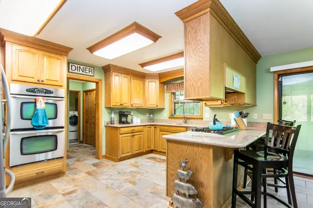 a bathroom with a sink a mirror and a window