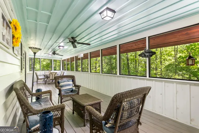 a living room with furniture a table and a chandelier