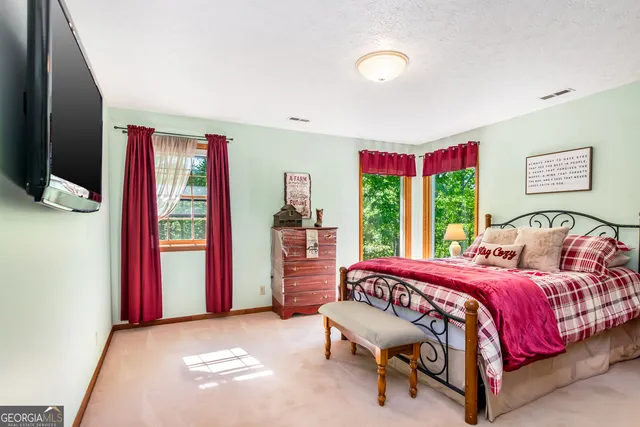 a bedroom with a bed and window