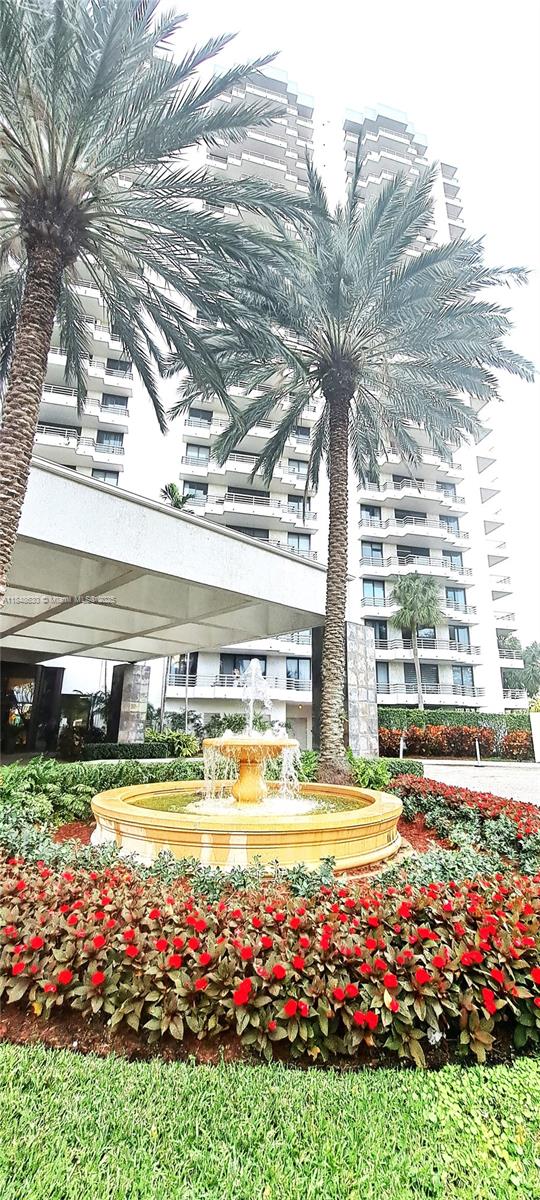 3300 Northeast 191st Street, Unit 1207 Aventura, FL 33180 - Photo 19 of 33 a view of an swimming pool with a yard and plants