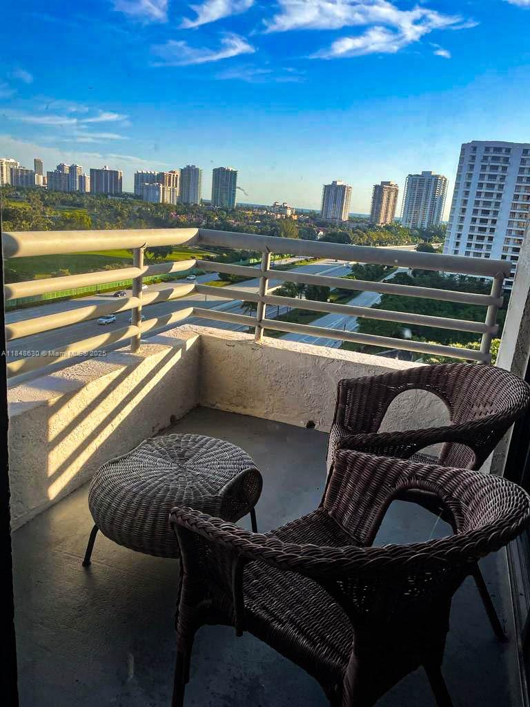 3300 Northeast 191st Street, Unit 1207 Aventura, FL 33180 - Photo 21 of 33 a view of a chairs and table in the terrace
