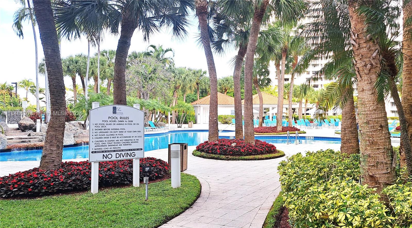 3300 Northeast 191st Street, Unit 1207 Aventura, FL 33180 - Photo 22 of 33 a front view of a house with a garden and trees