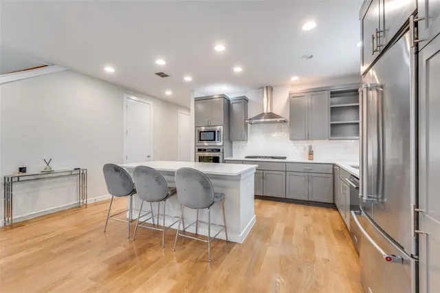 a kitchen with a sink cabinets and wooden floor