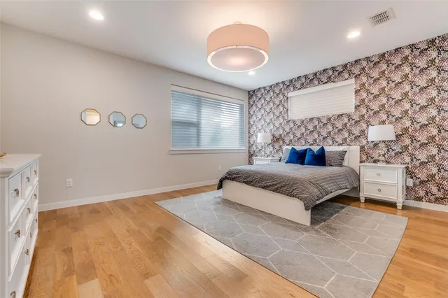 a bedroom with a large bed and a chandelier