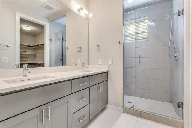 a bathroom with a shower sink and mirror