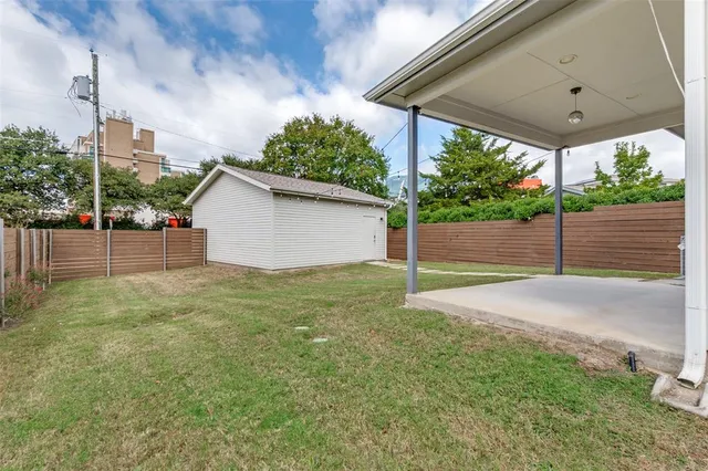 a backyard of a house with plants and outdoor seating