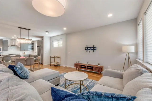 a living room with furniture a lamp and a large window