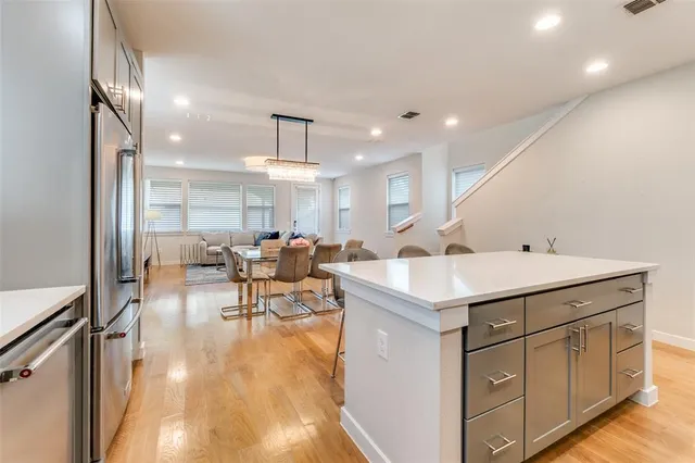 a living room with furniture a dining table and chairs