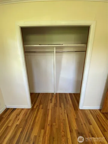 a view of closet with wooden floor