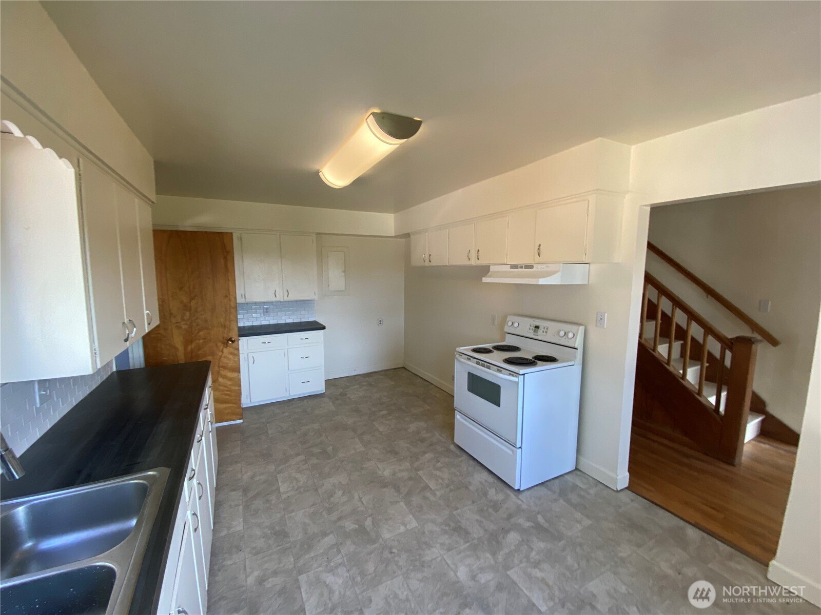 2312 38th Avenue Longview, WA 98632 - Photo 6 of 36 a kitchen with stainless steel appliances granite countertop a sink and a stove
