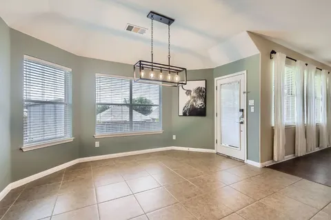 a view of livingroom with window hardwood floor and kitchen view