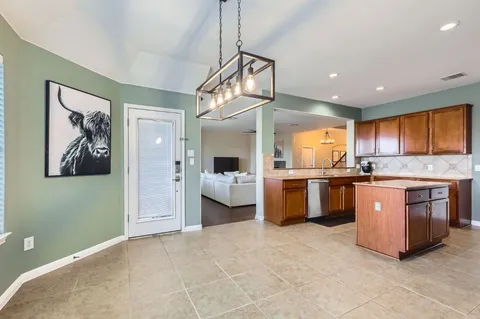 a view of kitchen with sink and window