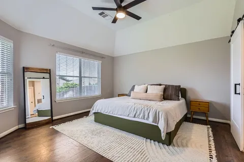 a bedroom with a large bed and a window