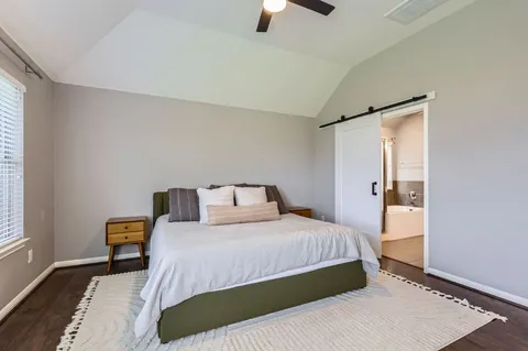 a bedroom with a bed and a lamp with window