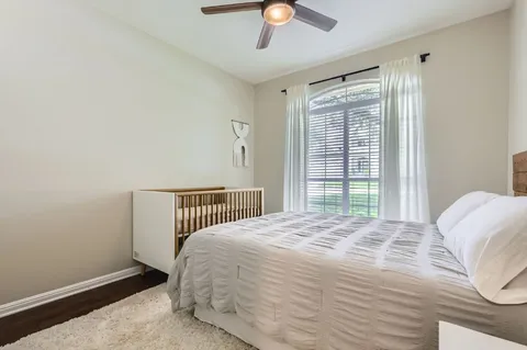 a bedroom with a bed and a chandelier