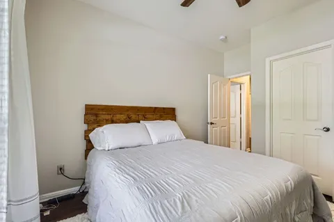 a bedroom with a bed and a night stand