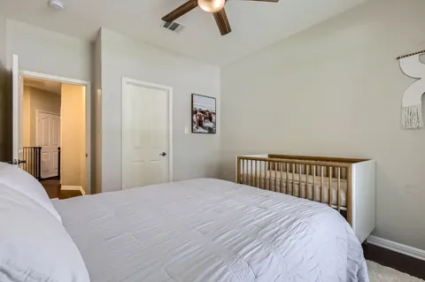 a bedroom with a large bed and a chandelier