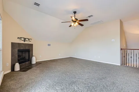 a view of empty room with fireplace