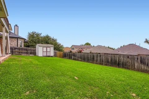 a view of a backyard with a garden and stairs