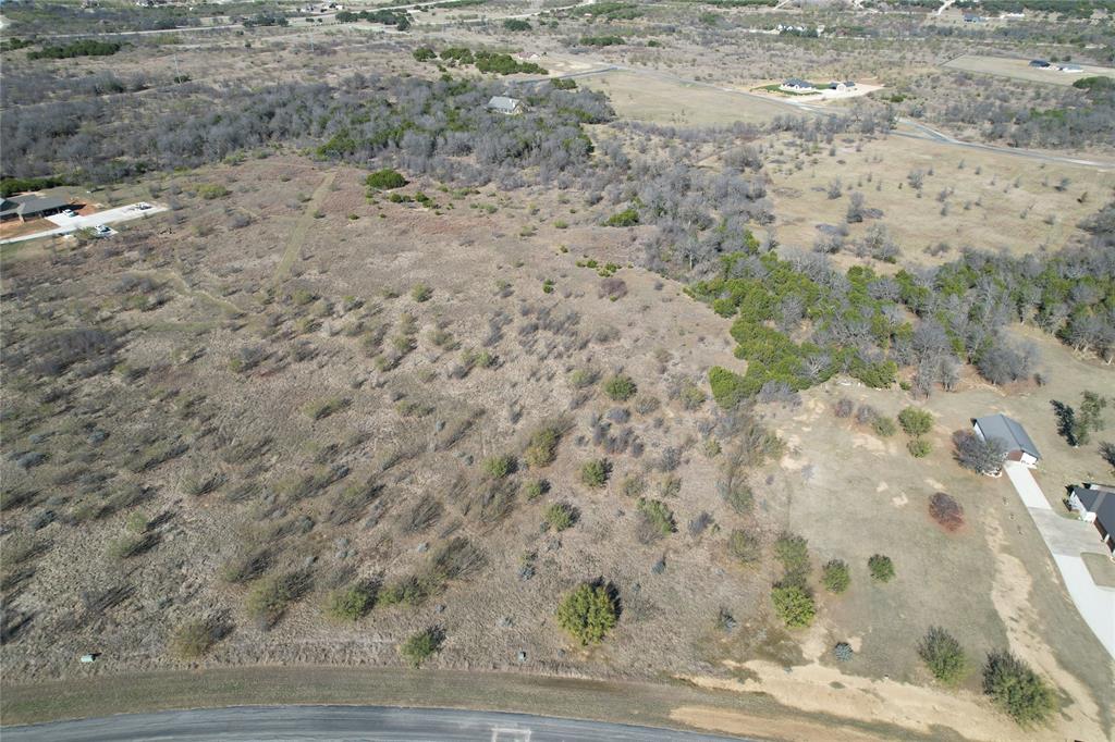 2045 Canyon Wren Loop Graford, TX 76449 - Photo 5 of 32 a view of a dry yard with wooden floor