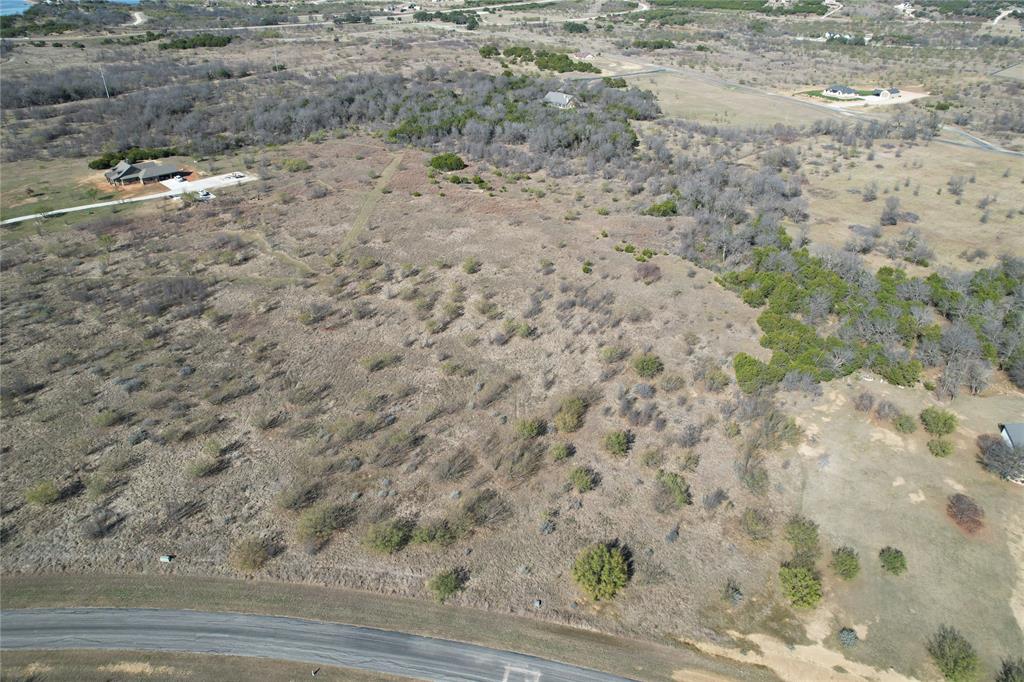 2045 Canyon Wren Loop Graford, TX 76449 - Photo 6 of 32 a view of a dry yard with wooden floor