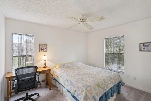 a bedroom with a bed a desk and chair