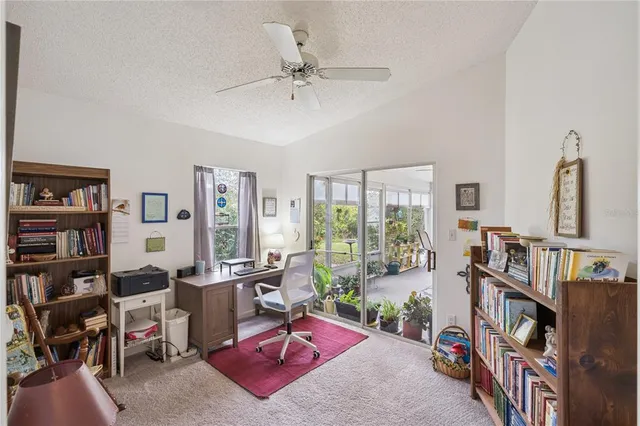 a living room with furniture and a book shelf