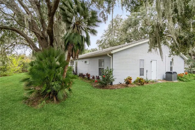 a view of backyard of house with green space