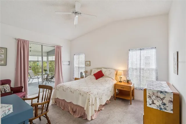 a bedroom with a bed chair and a large window