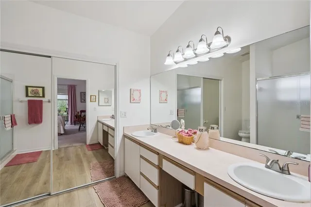 a spacious bathroom with a sink double vanity granite and a shower
