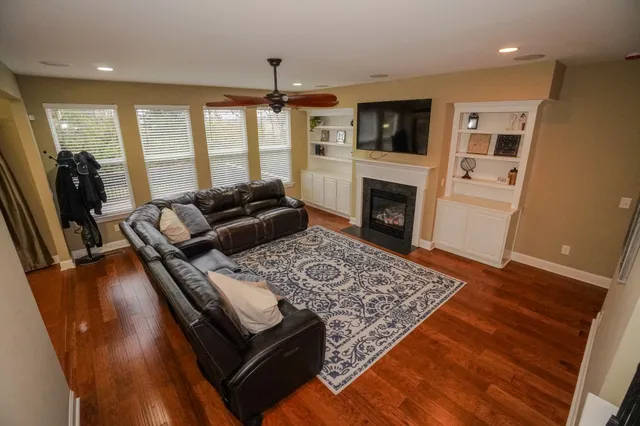 a bathroom with a tub sink vanity granite and shower