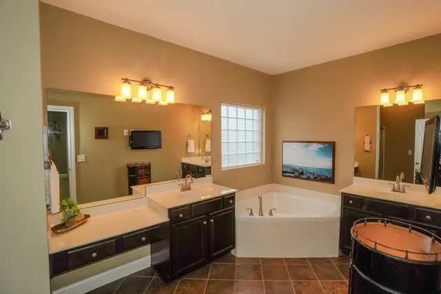 a view of a patio with dining table and chairs with wooden floor and fence